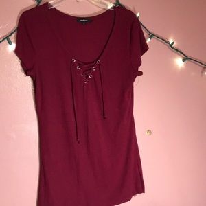 A maroon blouse with strings
